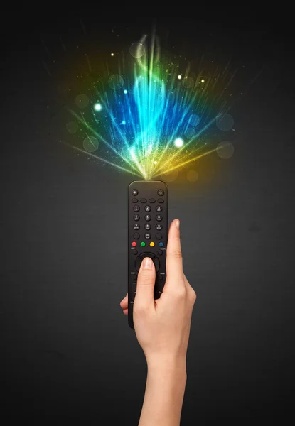 Hand with remote control and explosive signal — Stock Photo, Image