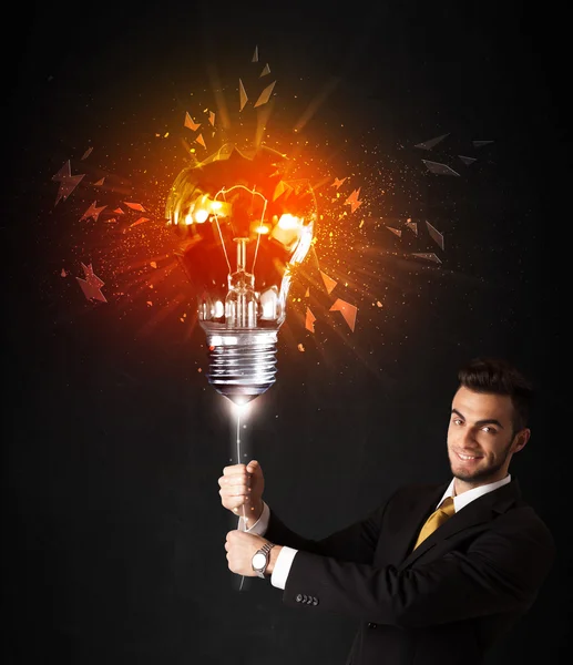 Businessman with an explosion bulb — Stock Photo, Image