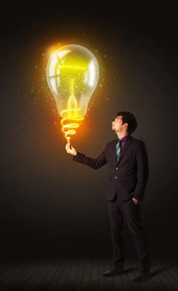 Businessman with an idea bulb — Stock Photo, Image