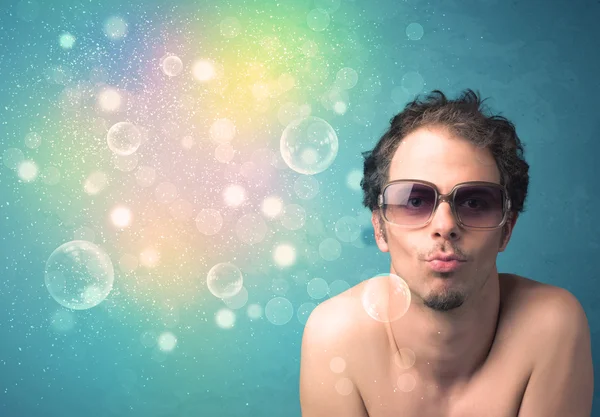 Young man with sunglasses and bokeh colourful lights — Stock Photo, Image