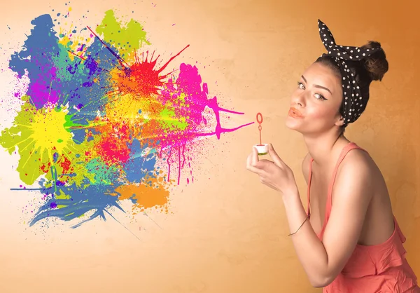 Cute girl blowing colorful splash graffiti — Stock Photo, Image