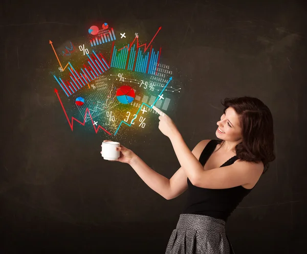 Businesswoman holding a white cup with diagrams and graphs — Stock Photo, Image