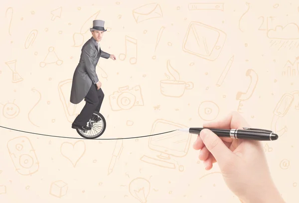 Businessman riding monocycle on a rope drawn by hand — Stock Photo, Image