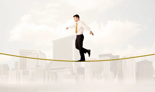 Business person balancing on golden rope — Stock Photo, Image