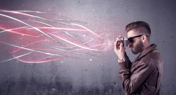 Elegant hipster with camera and bright lines — Stock Photo, Image