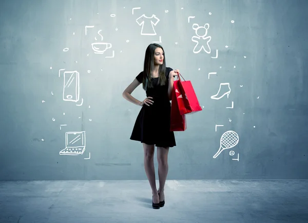 Shopping-Weibchen mit Taschen und gezeichneten Symbolen — Stockfoto