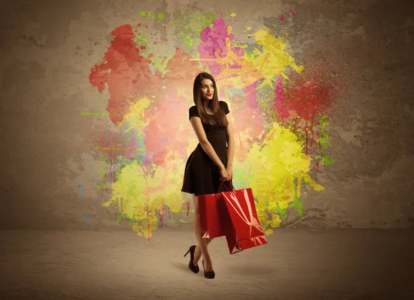 Chica con bolsas de compras y salpicaduras de pintura —  Fotos de Stock