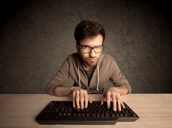 Computer geek typing on keyboard — Stock Photo, Image