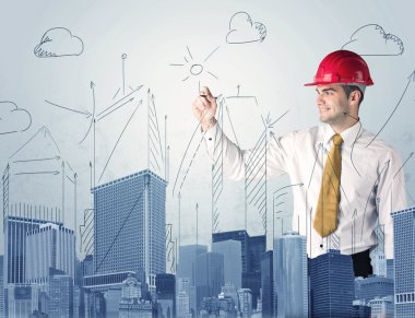 Genç işçi şehir manzarası çiziyor.