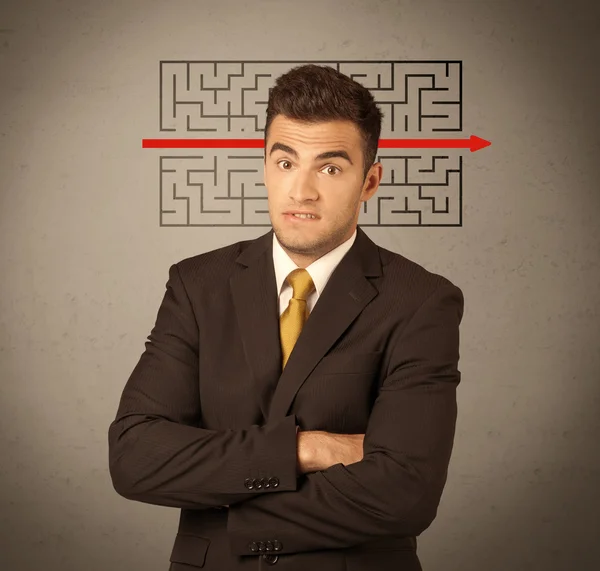 Handsome business guy solving maze — Stock Photo, Image