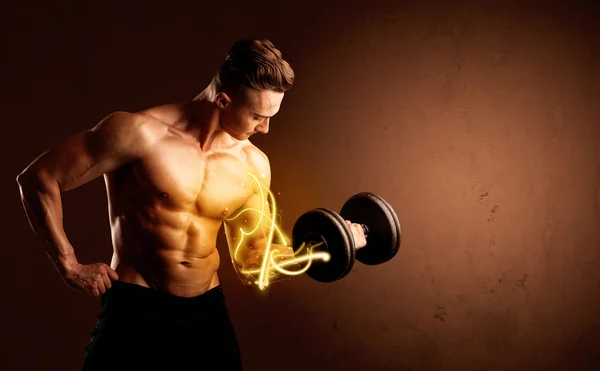 Muscular body builder lifting weight with energy lights on bicep — Stock Photo, Image