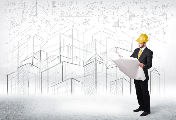 Handsome construction specialist with city drawing in background — Stock Photo, Image