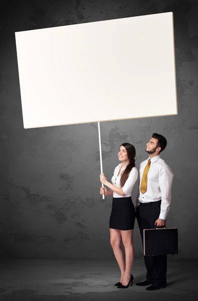 Business couple with blank whiteboard — Stock Photo, Image