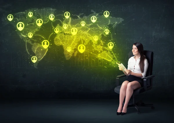 Businesswoman in office with tablet and social network world map — Stock Photo, Image