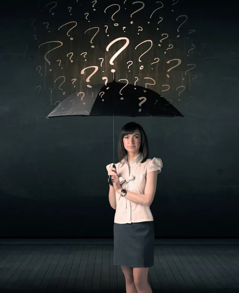 Businesswoman with umbrella and a lot of drawn question marks — Stock Photo, Image