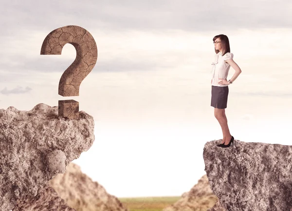 Businesswoman on rock mountain with a question mark — Stock Photo, Image
