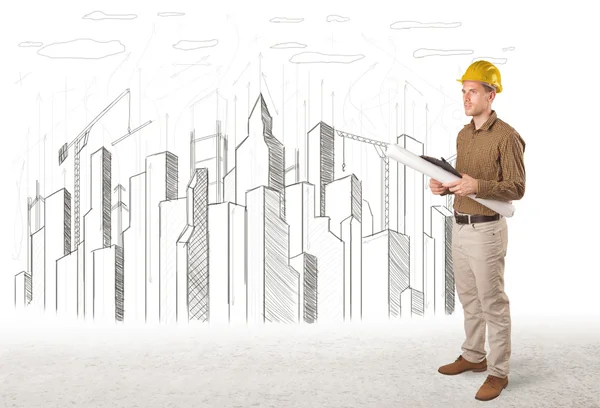 Engineer man with building city drawing in background — Stock Photo, Image