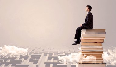 Labirynth kitaplarda oturan işadamı