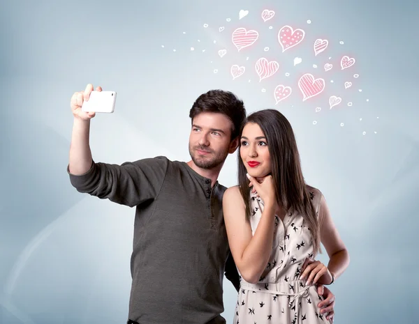 Couple in love taking selfie with red heart — Stock Photo, Image