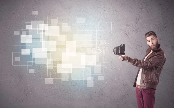 Hipster guy with retro camera in action — Stock Photo, Image