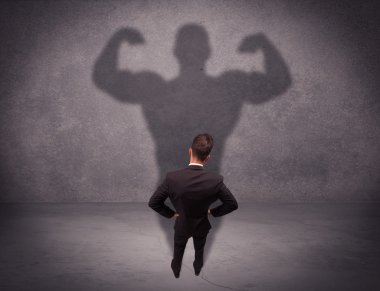 Successful businessman with strong shadow