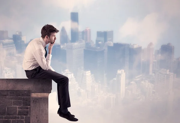 Sales person sitting on top of a tall building — Stock Photo, Image