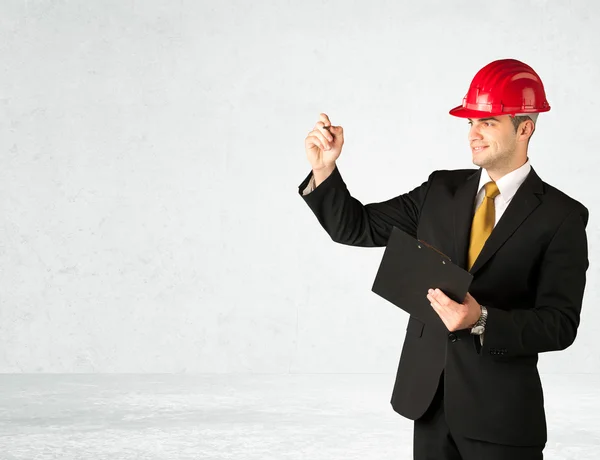 Young architect drawing in empty space — Stock Photo, Image