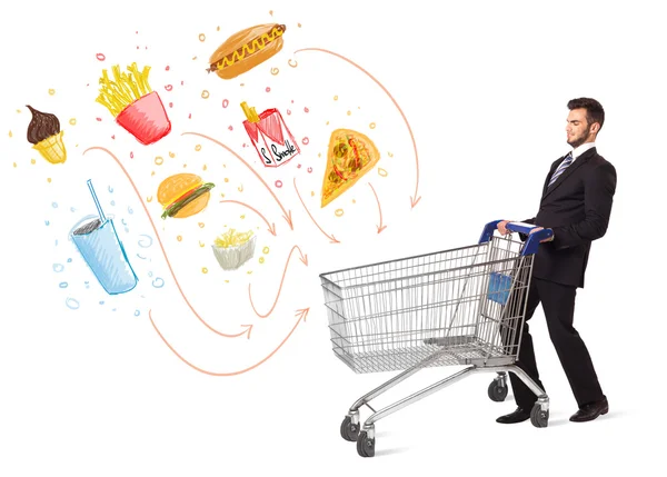 Man with shopping cart with toxic junk food — Stock Photo, Image