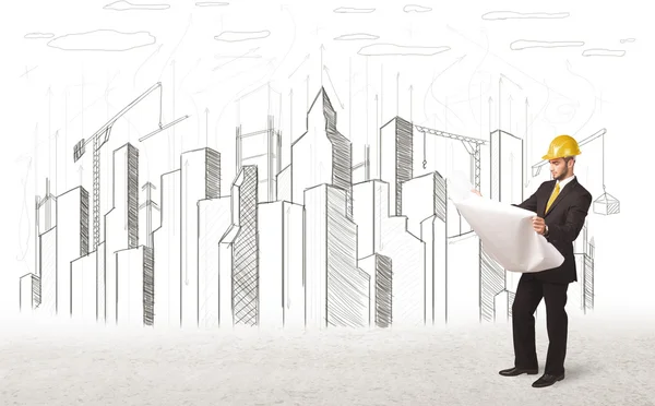 Engineer man with building city drawing in background — Stock Photo, Image