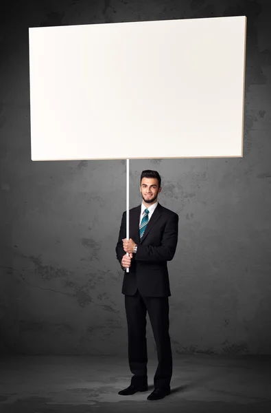 Businessman with blank whiteboard — Stock Photo, Image