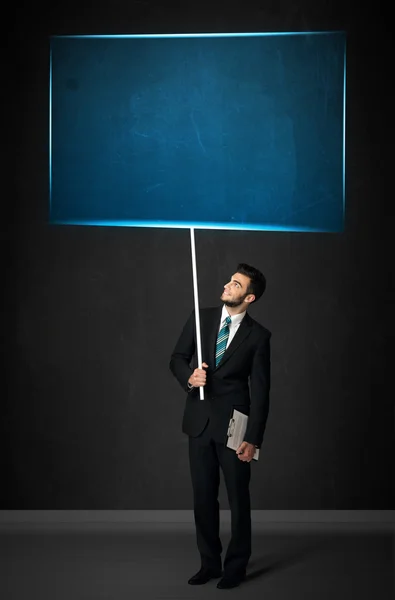 Businessman with blue board — Stock Photo, Image