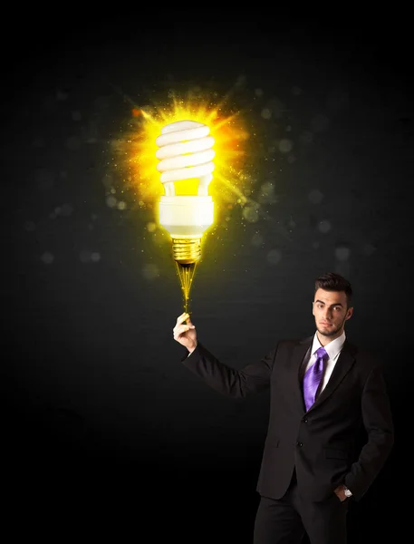 Businessman with an eco-friendly bulb — Stock Photo, Image