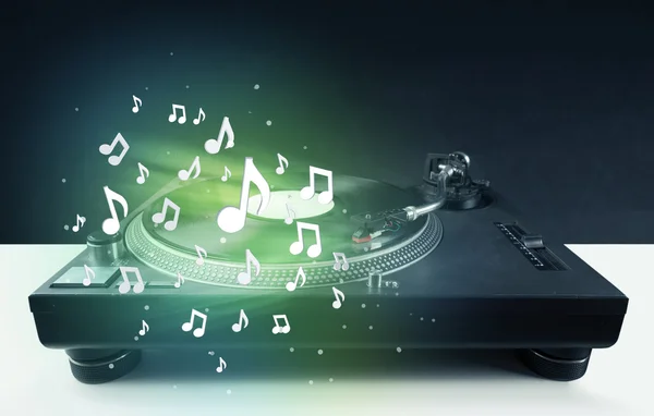 Turntable playing music with audio notes glowing — Stock Photo, Image