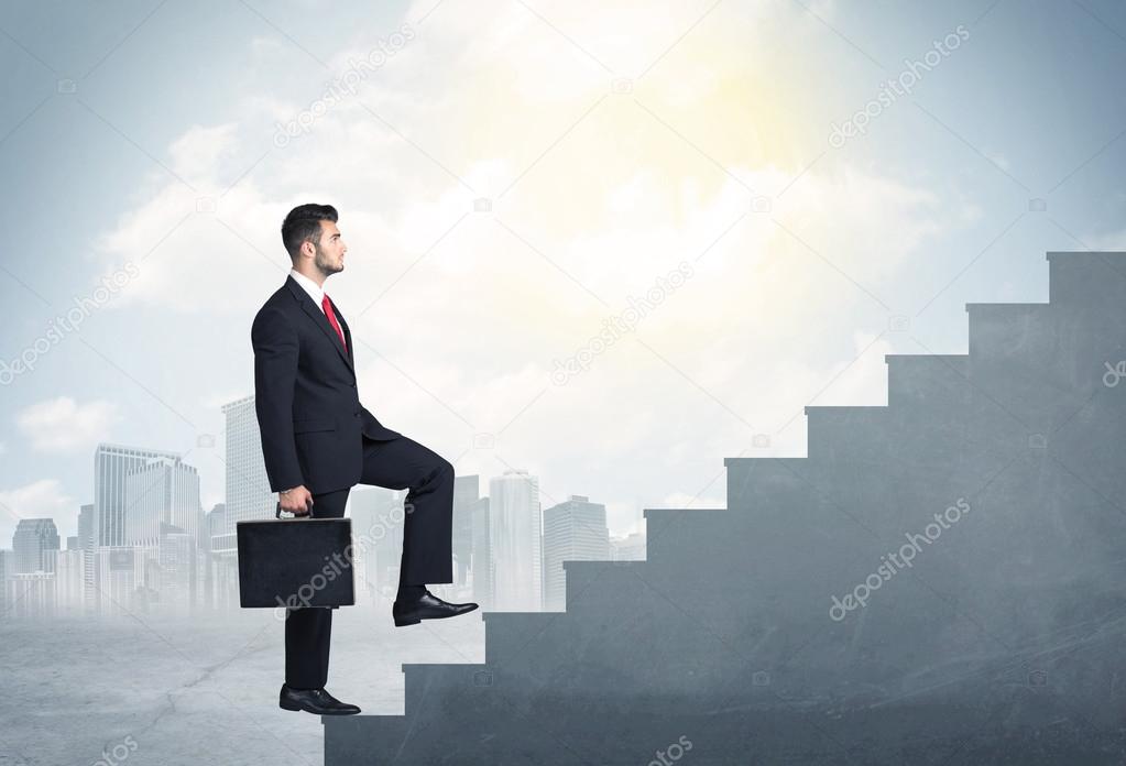 Businessman climbing up a concrete staircase concept