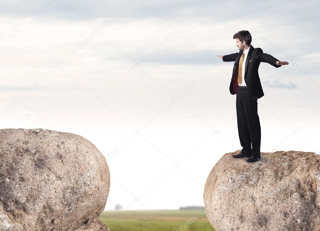 Businessman on rock mountain