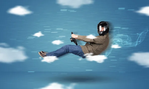 Funny racedriver young man driving between clouds concept — Stock Photo, Image