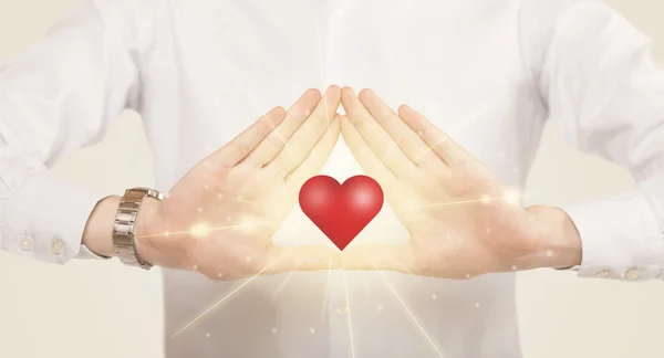 Hands creating a form with shining heart — Stock Photo, Image