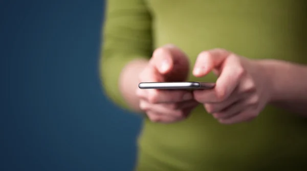 Mladá žena drží chytrý telefon v ruce — Stock fotografie