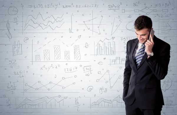 Salesman standing with drawn graph charts — Stock Photo, Image