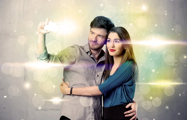 Sorridente coppia prendendo selfie in luce glitter — Foto Stock