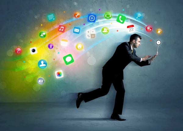 Running businessman with application icons from device — Stock Photo, Image