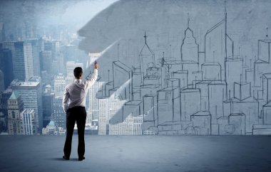 Zarif satıcı şehri duvarda yeniden boyuyor.