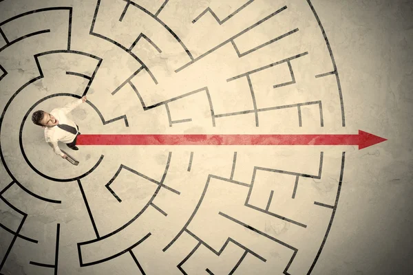 Business person standing in the middle of a circular maze — Stock Photo, Image