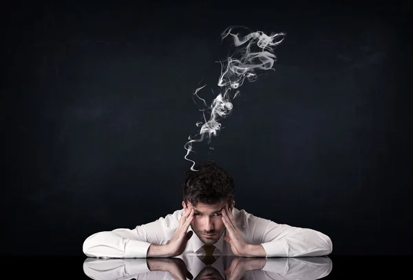 Depressed businessman with smoking head — Stock Photo, Image