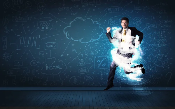 Happy business man jumping with storm cloud around him — Stock Photo, Image