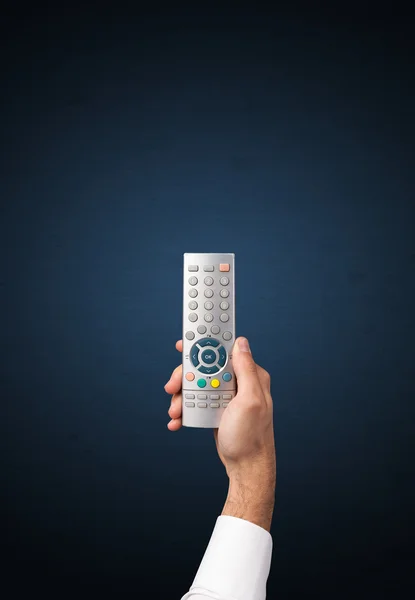 Hand with remote control — Stock Photo, Image