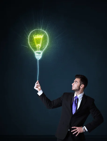 Businessman with an idea bulb — Stock Photo, Image