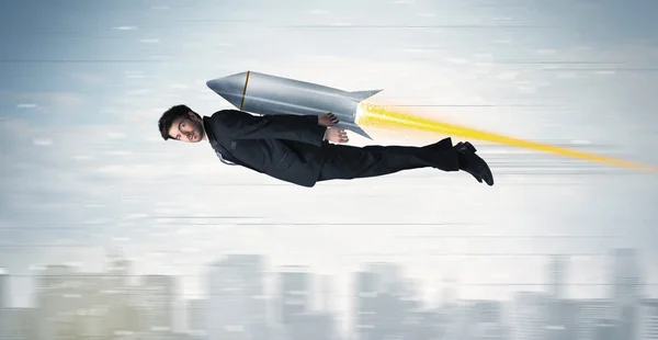 Superhero business man flying with jet pack rocket above the cit — Stock Photo, Image