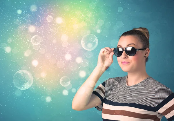 Young woman with sunglasses and bokeh colourful lights — Stock Photo, Image