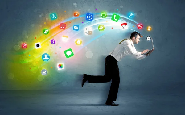 Running businessman with application icons from device — Stock Photo, Image